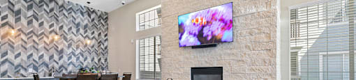 a living room with a fireplace and a table with chairs at Ascent Apartments, Cottonwood Heights, UT