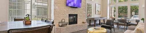 a living room with a fireplace and a table with chairs at Ascent Apartments, Cottonwood Heights, 84121