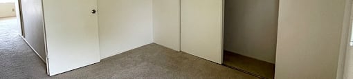 a bedroom with a closet and a carpeted floor at OTAVON APARTMENTS, Novato, 94947