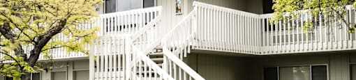 an exterior view of an apartment building with a white staircase at OTAVON APARTMENTS, Novato California