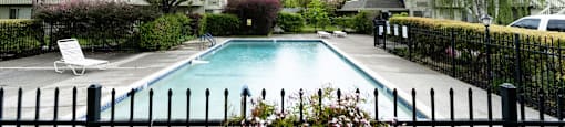 a swimming pool with a fence in front of it at OTAVON APARTMENTS, California, 94947