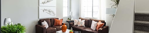a living room with couches and a coffee table at EVERETT APARTMENT HOMES, Las Vegas, NV, 89113