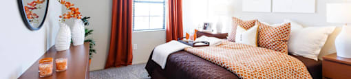 a bedroom with a bed and a dresser and a ceiling fan at EVERETT APARTMENT HOMES, Las Vegas, NV, 89113