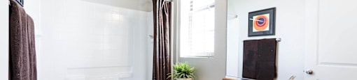 A bathroom at Everett with a sink toilet and shower. at EVERETT APARTMENT HOMES, Las Vegas, 89113