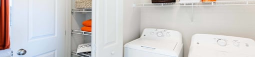 a white washer and dryer in a small laundry room at EVERETT APARTMENT HOMES, Las Vegas, 89113