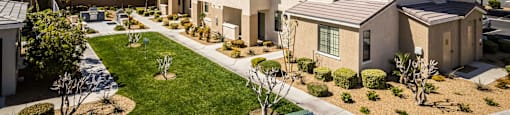 an aerial view of a row of houses with grass and a sidewalk at EVERETT APARTMENT HOMES, Nevada