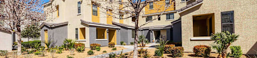 the front of a house with a yard and a sidewalk at EVERETT APARTMENT HOMES, Las Vegas, 89113