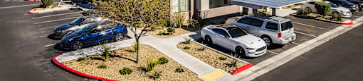 A row of apartment buildings at Everett and a cars in a parking lot. at EVERETT APARTMENT HOMES, Las Vegas, NV, 89113