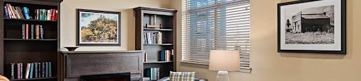 Seating by fireplace and bookshelves at TRADITIONS AT LAFAYETTE Apartments, LAFAYETTE , CO 80026