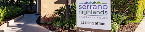 a leasing office sign in front of a building at SERRANO HIGHLANDS APARTMENT HOMES, Lake Forest, California