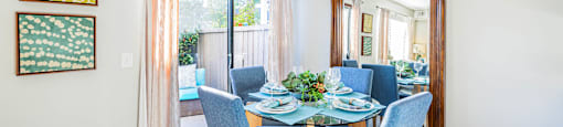 a dining room with a glass table and chairs at SERRANO HIGHLANDS APARTMENT HOMES, Lake Forest, 92630-7006