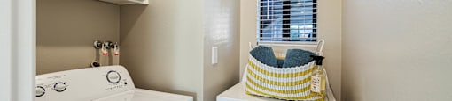 a washer and dryer in a laundry room with white cabinets at SERRANO HIGHLANDS APARTMENT HOMES, Lake Forest, CA, 92630-7006