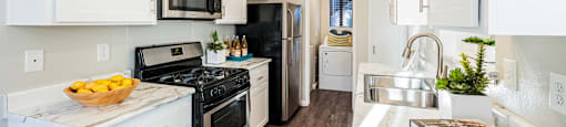a kitchen with white cabinets and black appliances at SERRANO HIGHLANDS APARTMENT HOMES, California