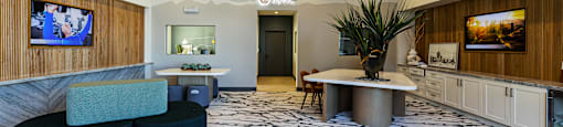 a large room with couches and a table in the middle at SYNC APARTMENT HOMES, North Las Vegas, 89084