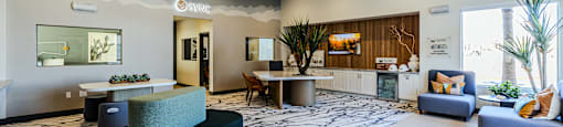 a lobby with couches tables and chairs and a reception desk at SYNC APARTMENT HOMES, North Las Vegas