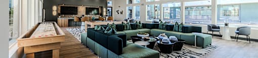 a large room with couches tables and chairs and a pool table at SYNC APARTMENT HOMES, North Las Vegas, 89084