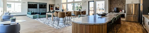 a clubhouse with a bar and a living room with couches at SYNC APARTMENT HOMES, Nevada, 89084