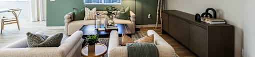 a living room with green walls and a couch and a table at SYNC APARTMENT HOMES, North Las Vegas, 89084