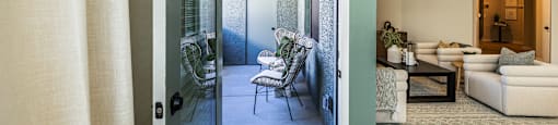an open door leading into a living room with a patio and a dining room at SYNC APARTMENT HOMES, North Las Vegas
