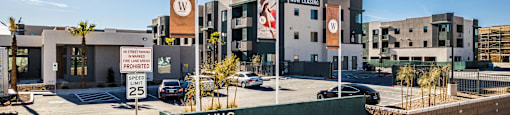 a building with a sign in front of a parking lot at SYNC APARTMENT HOMES, Nevada, 89084