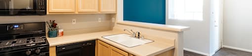 Kitchen sink view near accent wall at THE CLUBS AT RHODES RANCH APARTMENT HOMES, Nevada