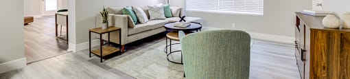 Edge on the Boulevard - Large Window, Neutral Couch, Circle Table, and Wood-Style Floors at The Edge on the Boulevard, California