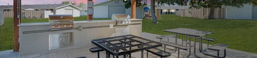 a patio with picnic tables and a grill at Cadence Apartments, Utah, 84067