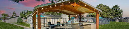 a patio with a picnic table and a pavilion with lights at Cadence Apartments, Utah