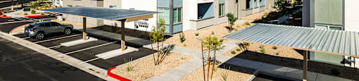 a new apartment building with a parking lot and a blue sky at BASE APARTMENT HOMES, LAS VEGAS, 89166