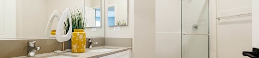 a bathroom with a sink and a shower at BASE APARTMENT HOMES, LAS VEGAS