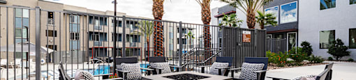 an outdoor patio with chairs and a fire pit at BASE APARTMENT HOMES, LAS VEGAS, Nevada