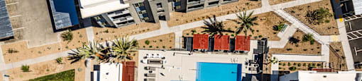 a birds eye view of a building with a blue pool at BASE APARTMENT HOMES, LAS VEGAS, NV 89166