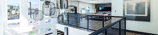 a large kitchen with a long counter and a staircase at BASE APARTMENT HOMES, LAS VEGAS