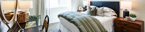 a bedroom with a bed and a desk with a mirror at BASE APARTMENT HOMES, LAS VEGAS, 89166