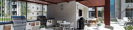 a patio with tables and chairs and a grill at BASE APARTMENT HOMES, LAS VEGAS, Nevada