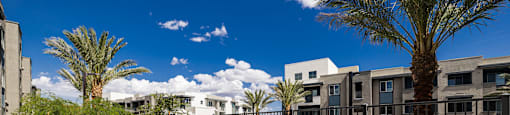 a patio with tables and chairs and a swimming pool at BASE APARTMENT HOMES, LAS VEGAS