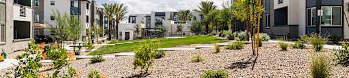 a view of a courtyard between two apartment buildings at BASE APARTMENT HOMES, LAS VEGAS