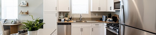 a kitchen with stainless steel appliances and white cabinets at BASE APARTMENT HOMES, LAS VEGAS, NV 89166
