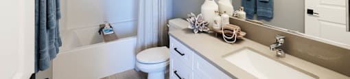 Bathroom with sink, counter, and mirror at BASE APARTMENT HOMES, LAS VEGAS, 89166