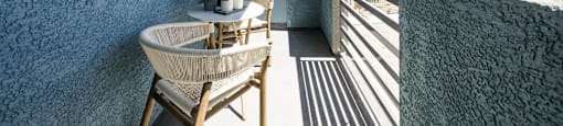a balcony or terrace with a table and chairs at BASE APARTMENT HOMES, LAS VEGAS, NV