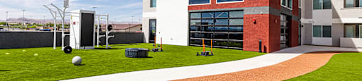 A red and white building with a green lawn in front.