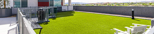 A red and white building with a green lawn in front.