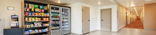 A long hallway with a vending machine on the left.