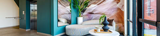 A room with a blue wall and a white bench.