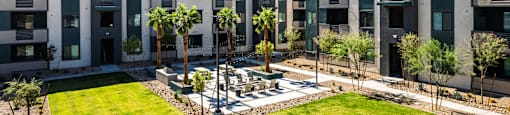 an aerial view of an apartment complex with grass and palm trees