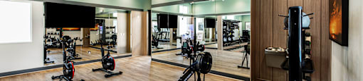 a gym with weights and other exercise equipment on a wooden floor