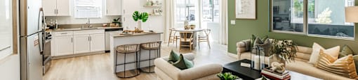 a living room and kitchen with a couch and a table