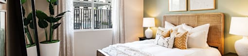 bedroom with large window and ceiling fan at the preserve at greatstone