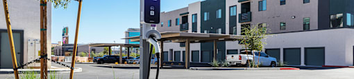 a parking meter in front of an empty parking lot