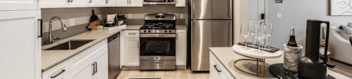 a kitchen with stainless steel appliances and white cabinets